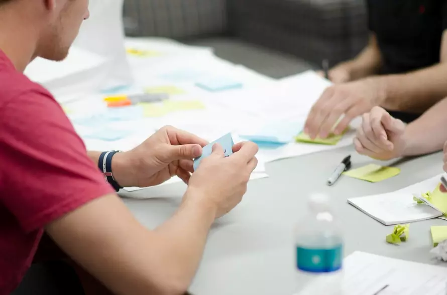 a person holding a sticky notes